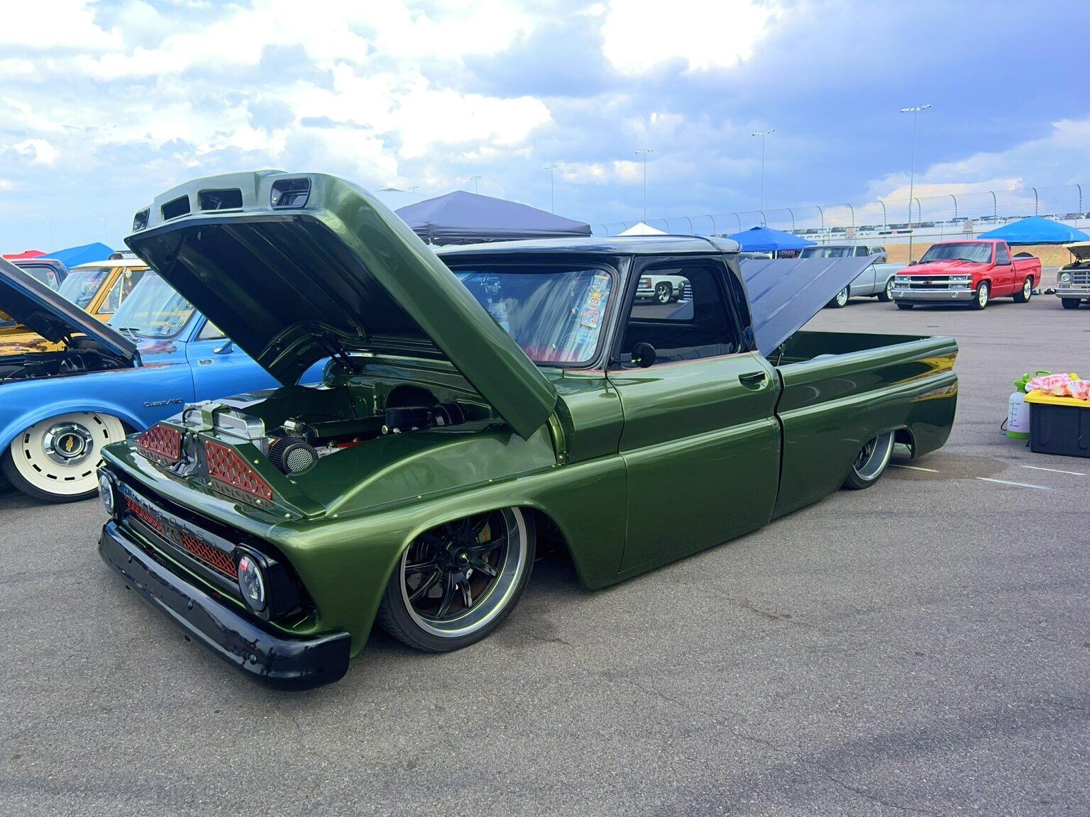 Green lowered Chevrolet C10 with its hood open
