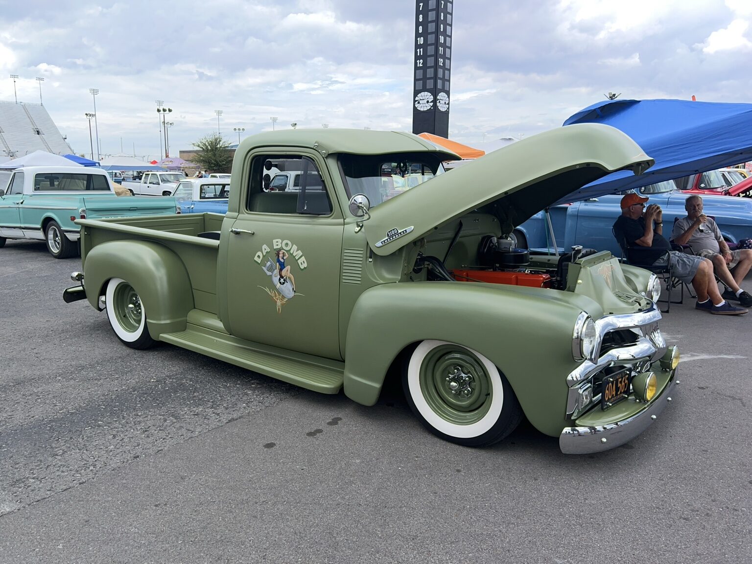 Olive green classic Chevrolet pickup with whitewall tires