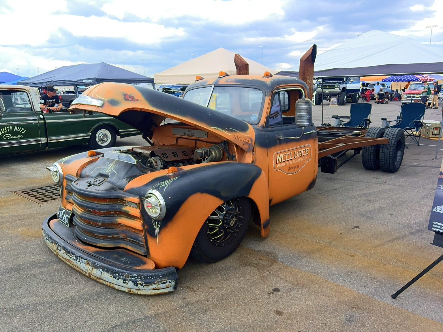 Orange patina vintage Chevrolet shop truck with its hood open