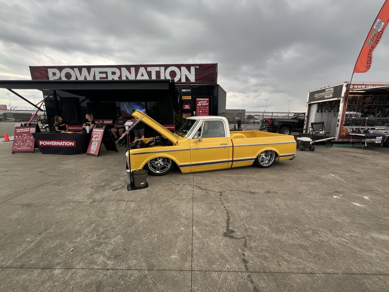 Yellow lowered Chevrolet square-body truck at the PowerNation display