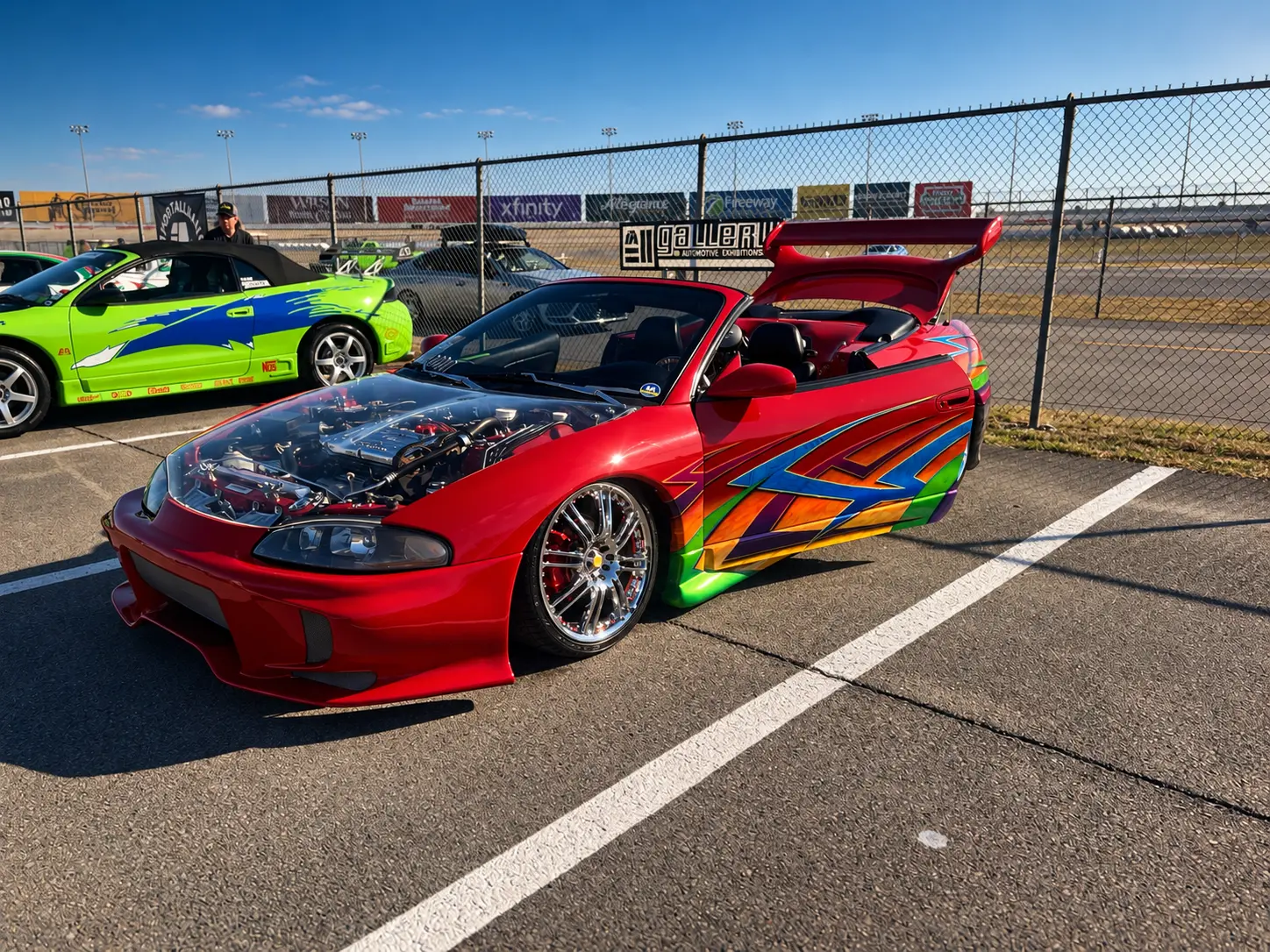 Red custom coupe with bright multicolor graphics at ImportAlliance Nashville Fall 2026