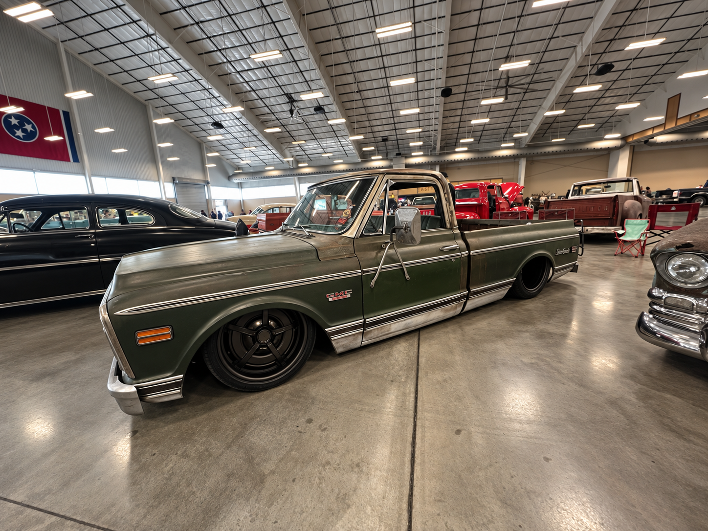 Lowered green GMC pickup inside the Fall Redneck Rumble 2026
